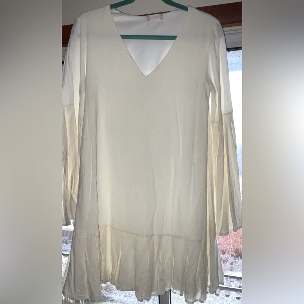 Altar'd State cream dress. Flowing sleeves and ruffled edge hem.